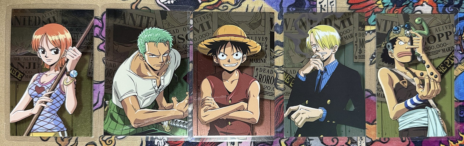 All five lami cards in a row, wanted-poster collage backgrounds visible