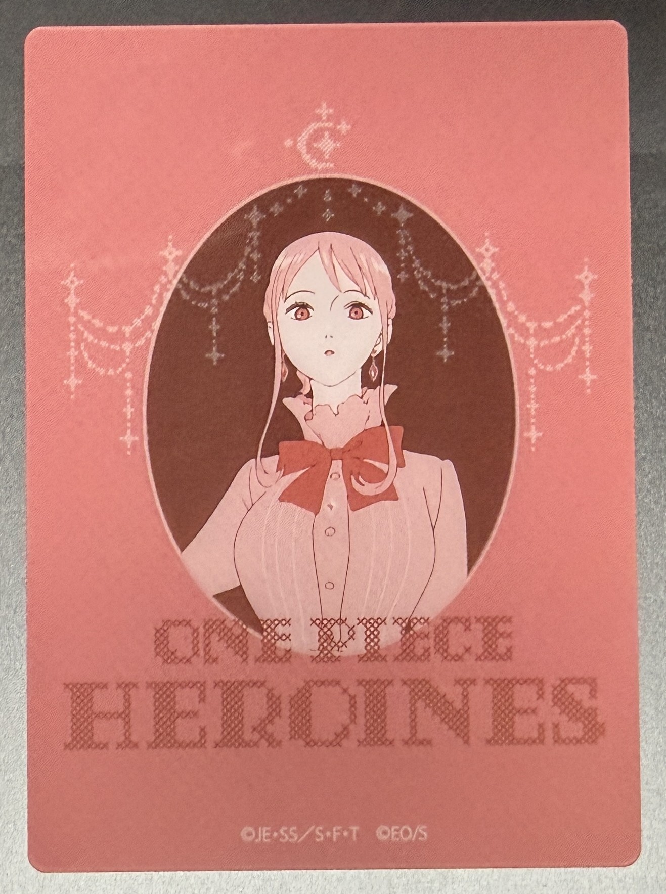 Nami clear card, red oval cameo design with cross-stitch title
