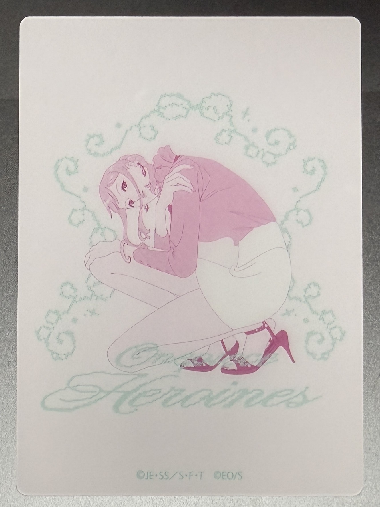 Nami clear card, crouching in pink inside a mint vine frame
