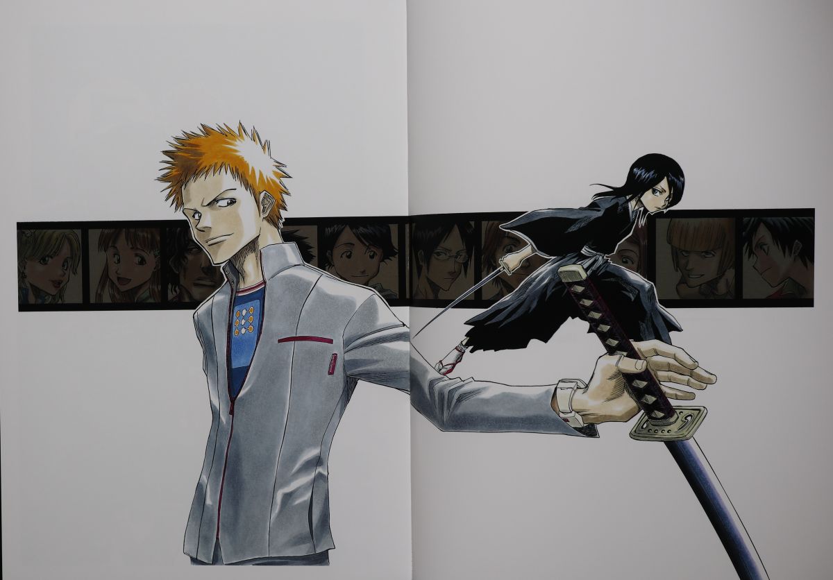 Spread of Ichigo holding his sword with Rukia standing on the blade